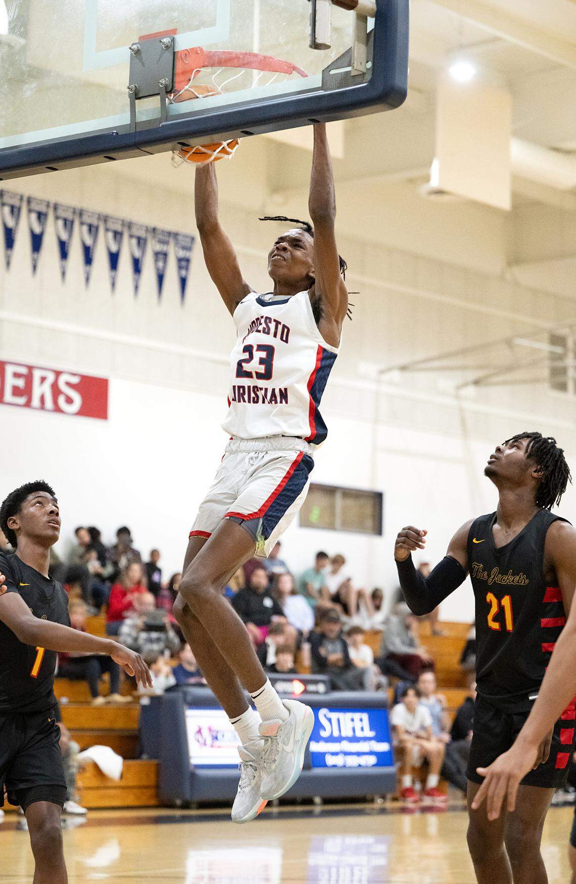 Modesto Christian’s Drevon Johnson dunks the ball during a non-league game with Berkeley at Modesto Christian High School in Salida, Calif., Saturday, Dec. 16, 2023.