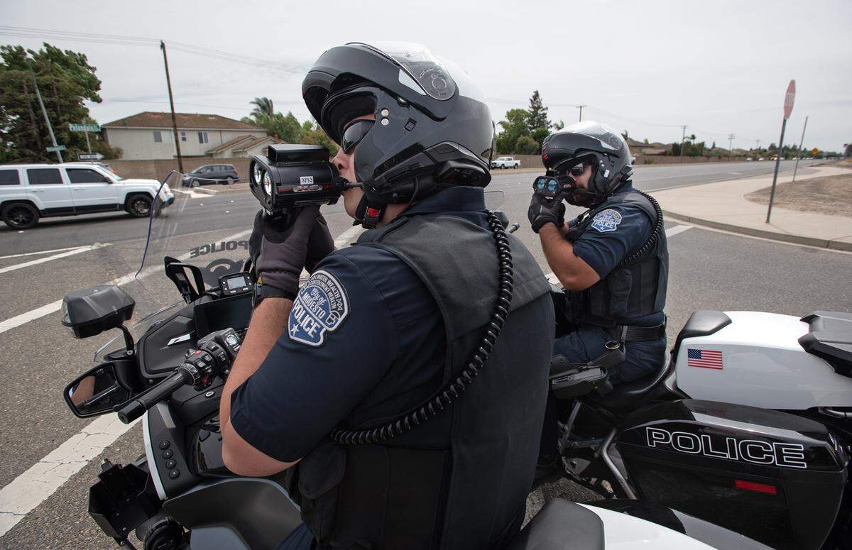 Modesto Police officers Ryan Olson, left, and Jorge Contreras check motorists’ speed on Pelandale Road in Modesto, Calif., on Thursday, May 5, 2022. The California Office of Traffic Safety ranked Modesto worst among its peer cities for traffic crashes. The ranking is for 2019, which is the latest year for which OTS has statistics, and places Modesto first among 59 California cities with 100,000 to 250,000 residents. Modesto’s population is about 220,000 residents.