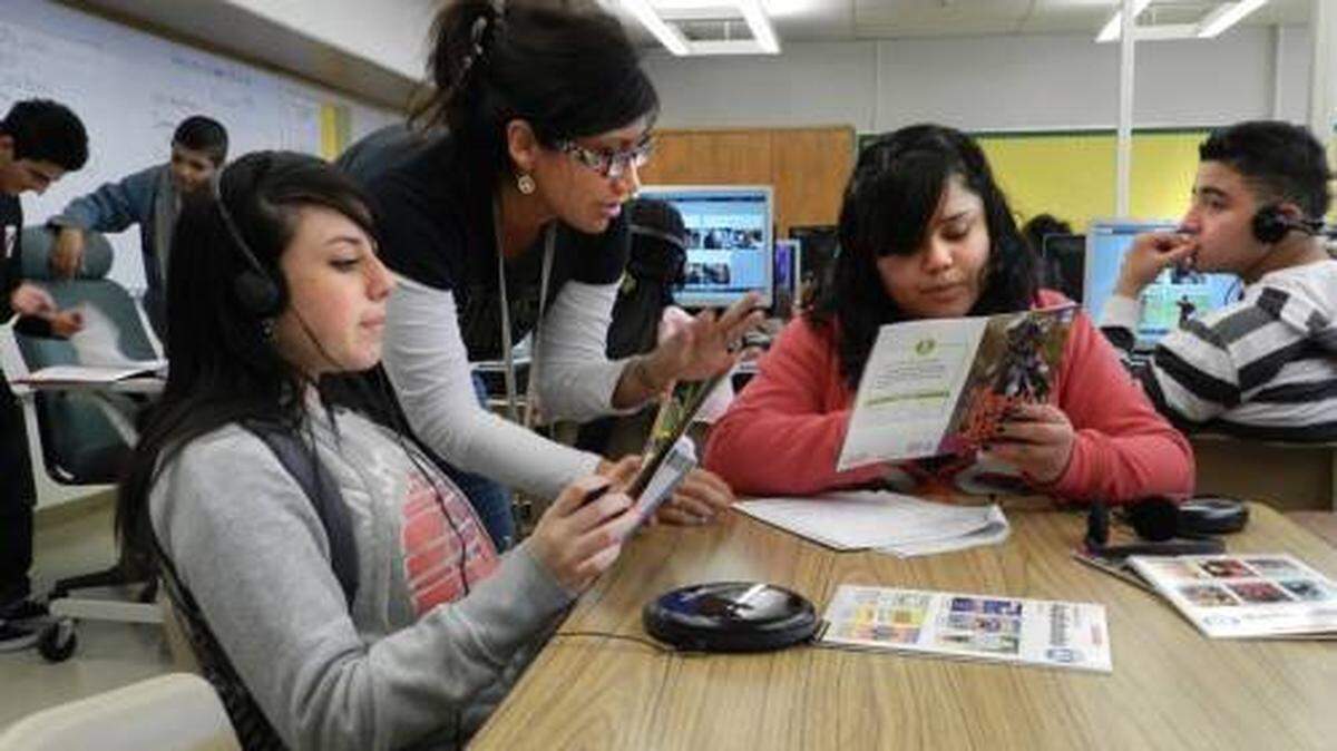 Language Institute teacher works with students at Davis High School in Modesto.