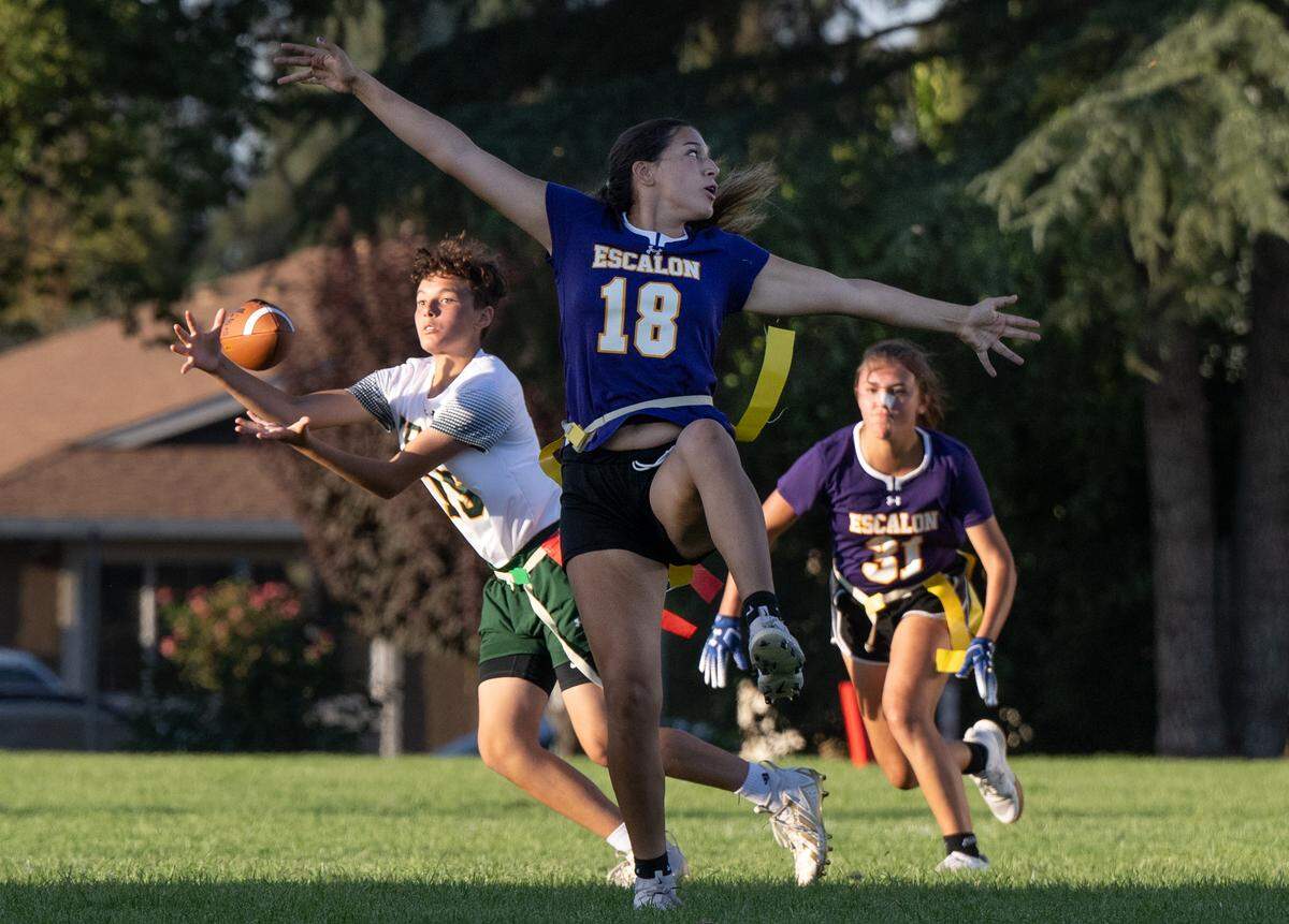 Tracy’s Addison Riddle makes a catch behind Escalon’s Helena Arroyo (18) during the game in Escalon, Calif., Wednesday, Sept. 13, 2023.