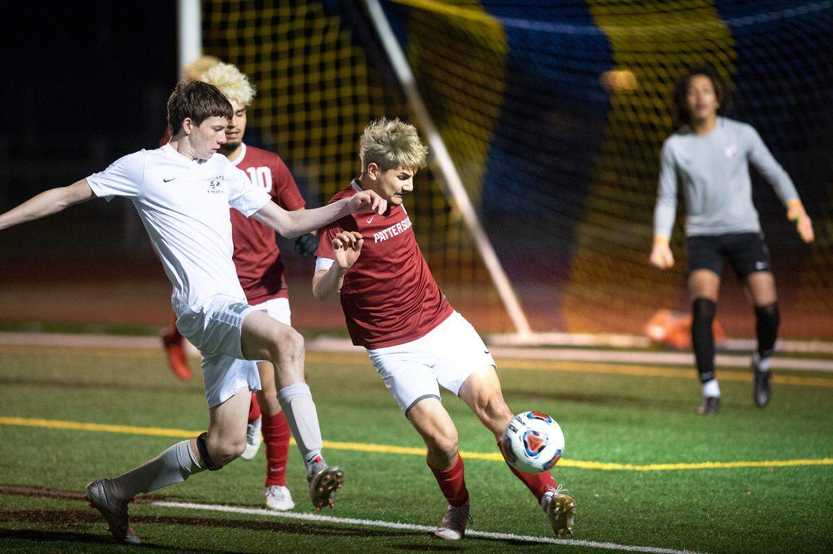Patterson’s Antonio Gallegos clears the ball under pressure from Vista del Lago’s Daniel Klos in the Sac-Joaquin Section Division III title game at Turlock High School in Turlock, Calif., on Tuesday, Feb. 22, 2022. Vista del Lago won the championship 2-0.