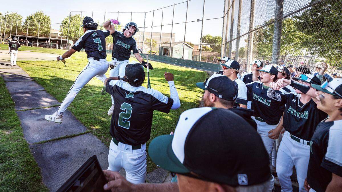 Pitman’s Andrew Balentine and Max Martinez (7) celebrate a run with their teammates during Sac-Joaquin Section Division 2 baseball playoff game with Rodriguez at Pitman High School in Turlock, Calif., Thursday, May 11, 2023. Pitman won the game 9-5.