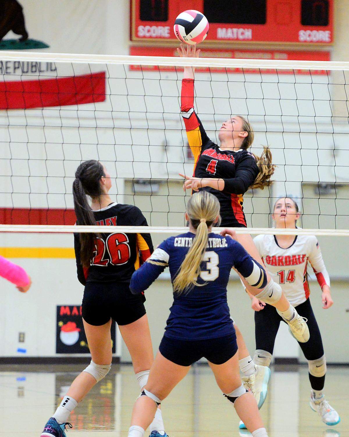 Oakdale’s Avery Gleason (4) spikes the ball during a game between Oakdale and Central Catholic at Oakdale High School in Oakdale, Calif. on Thursday, Oct. 17, 2024.&nbsp;