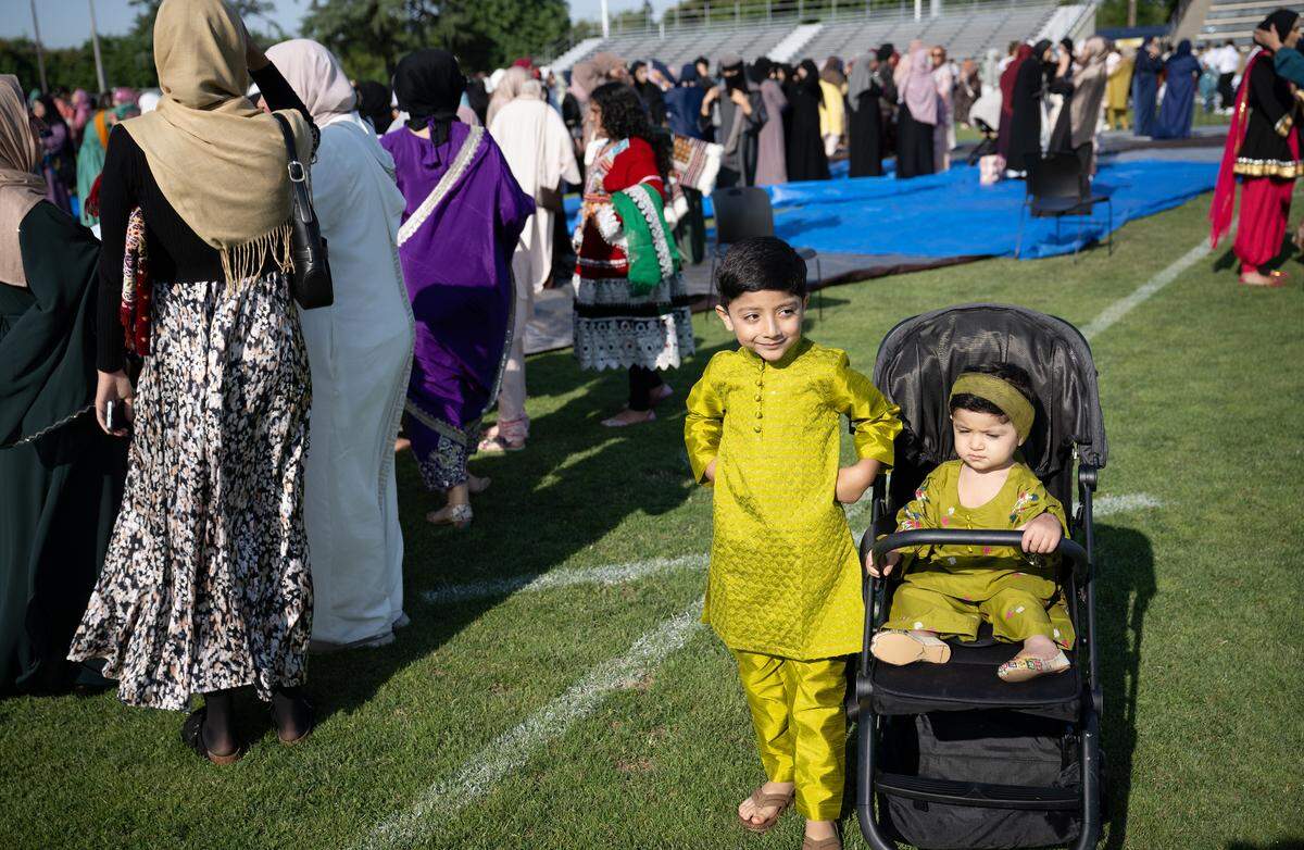 Muhammad Sabat, 6, and and his sister Hoora attend an Eid prayer at Modesto Junior College in Modesto, Thursday, June 6, 2025.