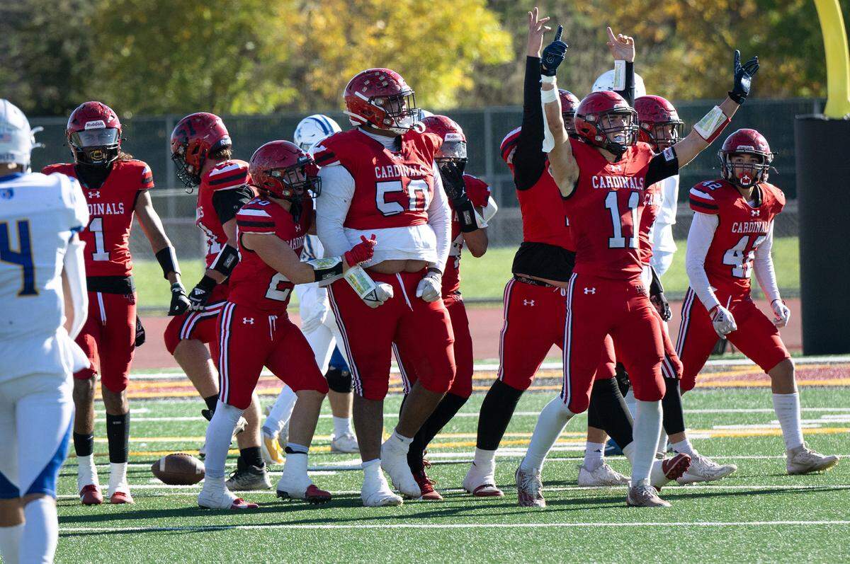 Woodland Christian players celebrate after a Noah Rico (50) interception during the Sac-Joaquin Section Division VII NorCal Qualifier with Ripon Christian at Sacramento City College in Sacramento, Calif., Saturday, Nov. 25, 2023.