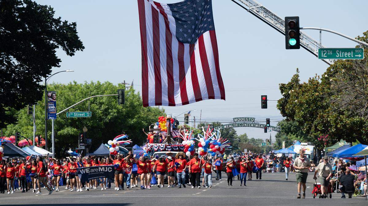 Modesto Junior College proceeds down I Street during the Independence Day Parade in Modesto, Calif., Tuesday, July 4, 2023.