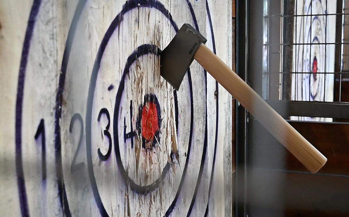 Sharpened axes are thrown at wood panel target using the scoring system of other shooting or throwing games including darts or corn hole. Photograhed at Smart Axe Modesto’s ax-throwing bar in Modesto, Calif., on Thursday, May 13, 2021.