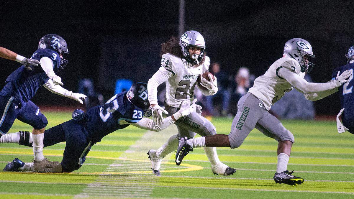 Granite Bay’s Isaiah Ene runs the ball during the CIF Sac-Joaquin Section Division II playoff game at Downey High School in Modesto, Calif., Friday, Nov.11, 2022.