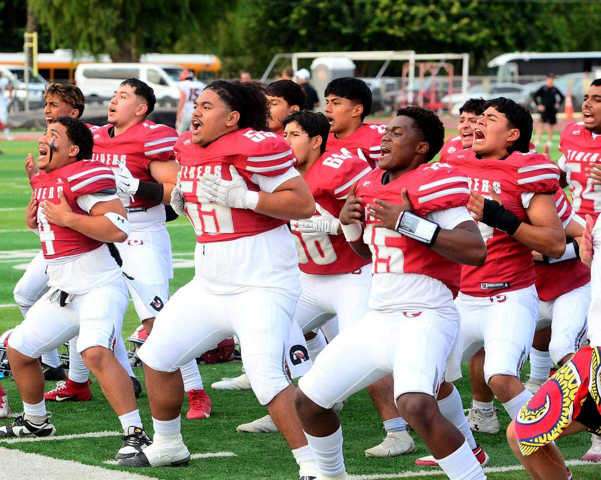 Patterson players perform a haka before a game between Patterson High School and Merced High School at Patterson High on Aug. 23, 2024.