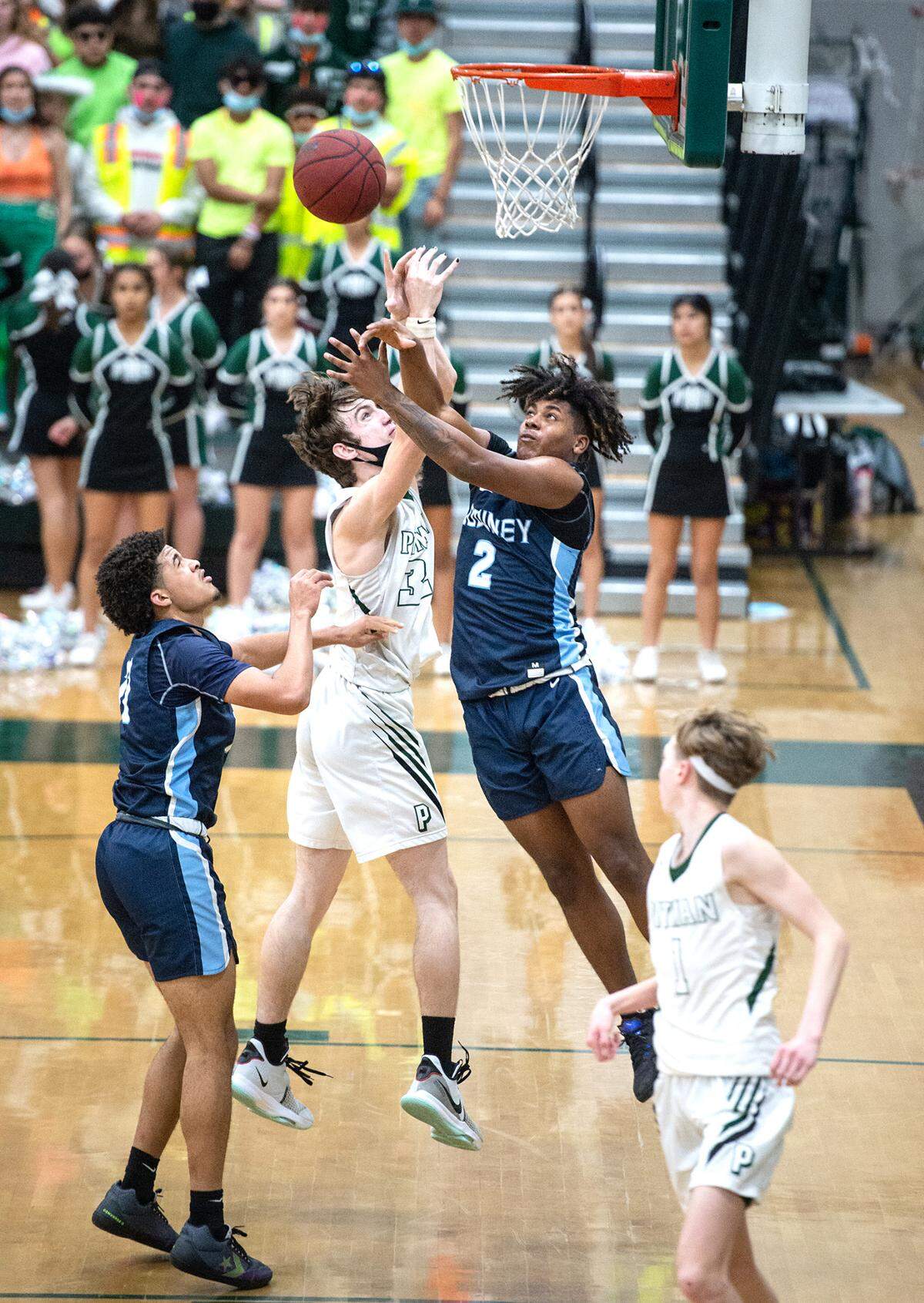 Downey’s Jahmaree Gonder, right, and Pitman’s Robert Salmon battle for a rebound during the Central California Athletic League game at Pitman High School in Turlock, Calif., on Friday, Feb. 4, 2022. Downey won the game 56-52.
