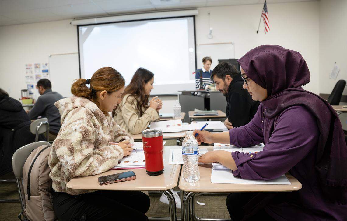 Hangama Amirpoor, right, works with Maria Quijano, left, on a group exercise during an English language class for nursing assistant students at Modesto Junior College.