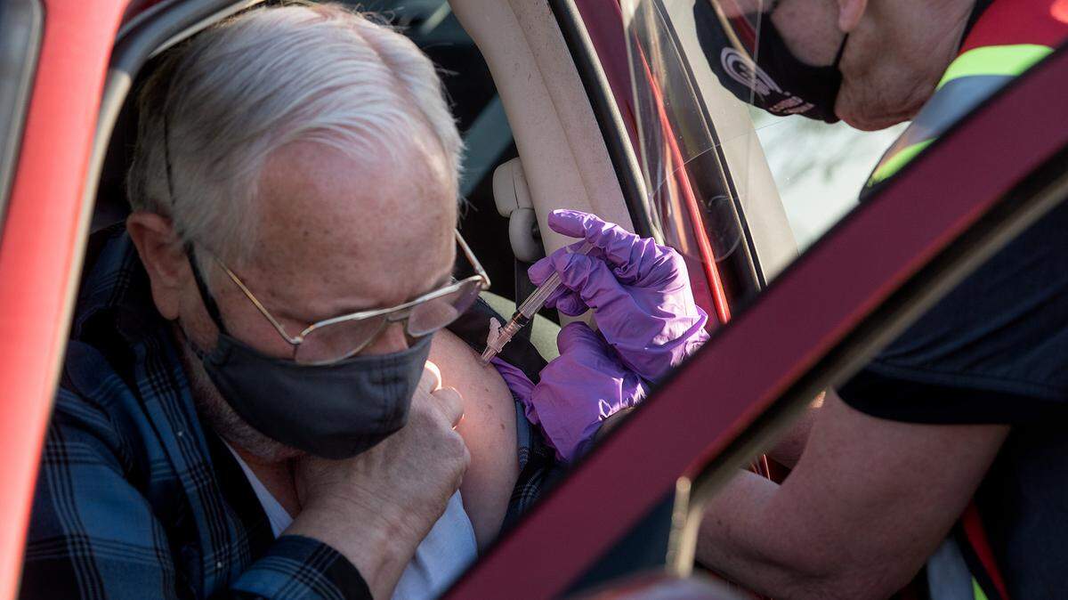 Nurse Tamara Love gives Lynn Powell a flu shot as the Stanislaus County Department of Public Health conducts a drive-thru mass vaccination clinic for the flu vaccine at Johansen High School in Modesto, Calif., on Friday, Dec. 4, 2020.