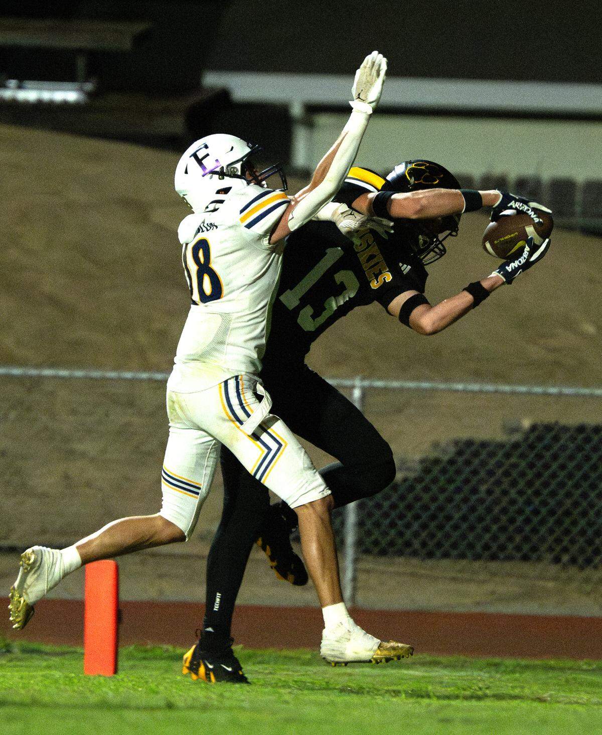 Hughson’s Bryce McDaniel (13) makes a touchdown grab past Escalon’s Chase Cummings during the Trans Valley League game with Escalon in Hughson, Calif., Friday, Oct. 4, 2024.
