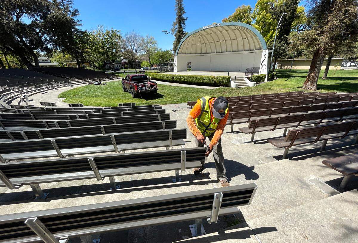 Installer David Corral makes final touches to the new bleachers at Mancini Bowl at Graceada Park in Modesto, Calif., Thursday, April 20, 2023.