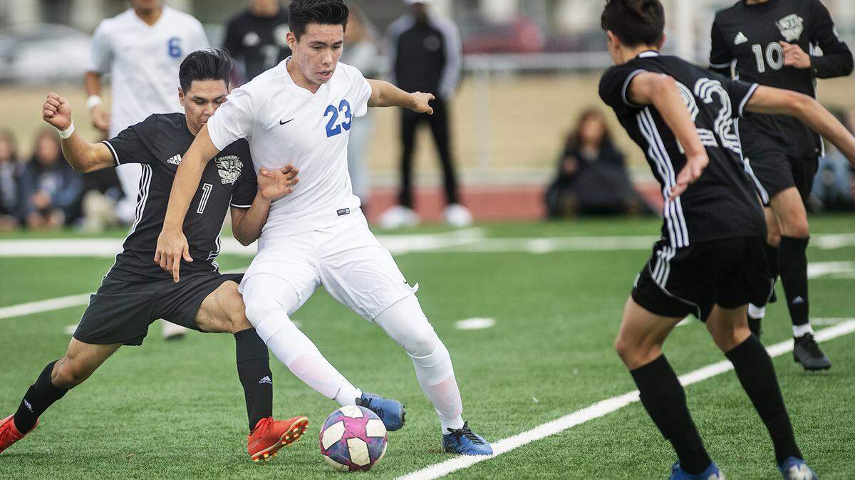 Turlock’s Eduardo Garcia (23) dribbles while and Pitman’s Alexis Benites Miranda (11) defends during the Central California Athletic League game at Pitman High School in Turlock, Calif., on Wednesday, Jan. 22, 2020. 