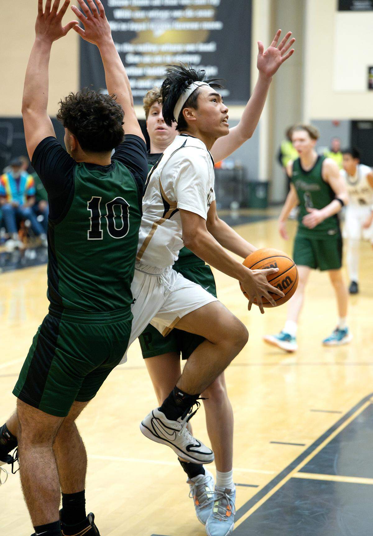 Enochs’ Roshaun Belleza splits Pitman defenders on a drive to the hoop during the Central California Athletic League game at Enochs High School in Modesto, Friday, Jan. 24, 2025.