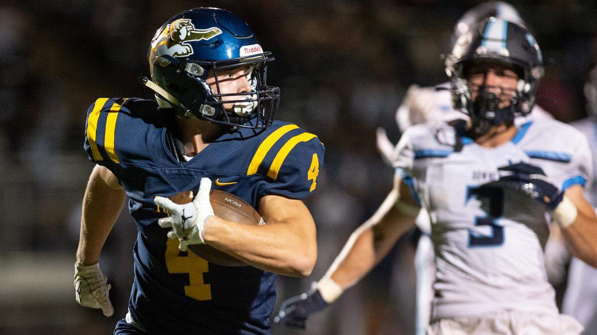 Turlock’s Peter Mello runs in for a touchdown during the Central California Athletic League game with Downey in Turlock, Calif., Friday, Oct. 7, 2022.