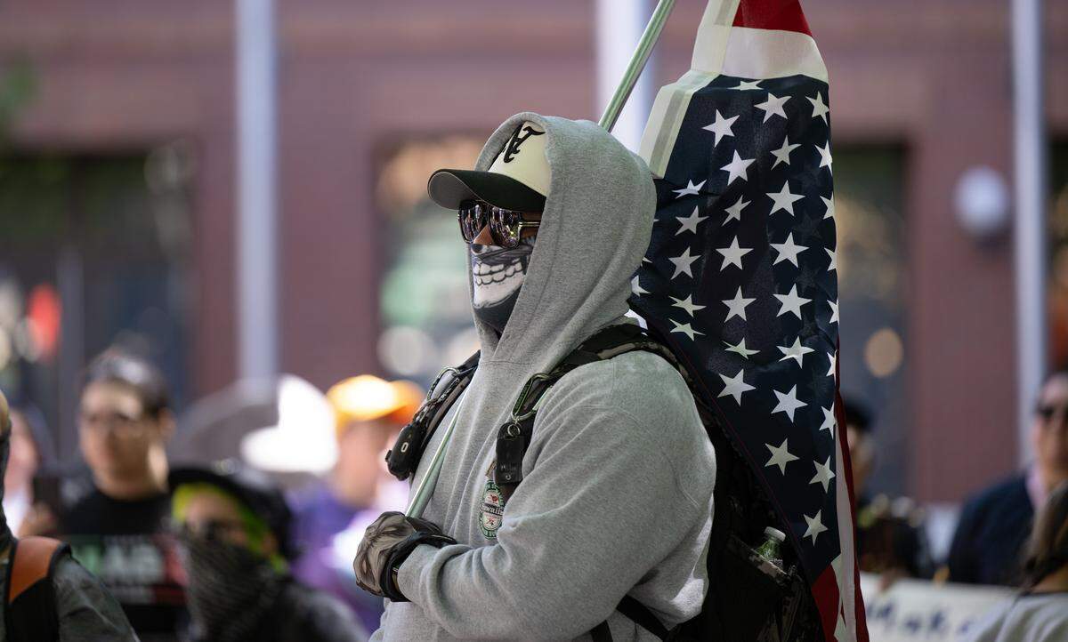 A few protesters were detained by Modesto police, at least one for allegedly wearing a mask with an intent to commit a crime, during a rally at Tenth Street Plaza in Modesto on Saturday, June 14, 2025. 