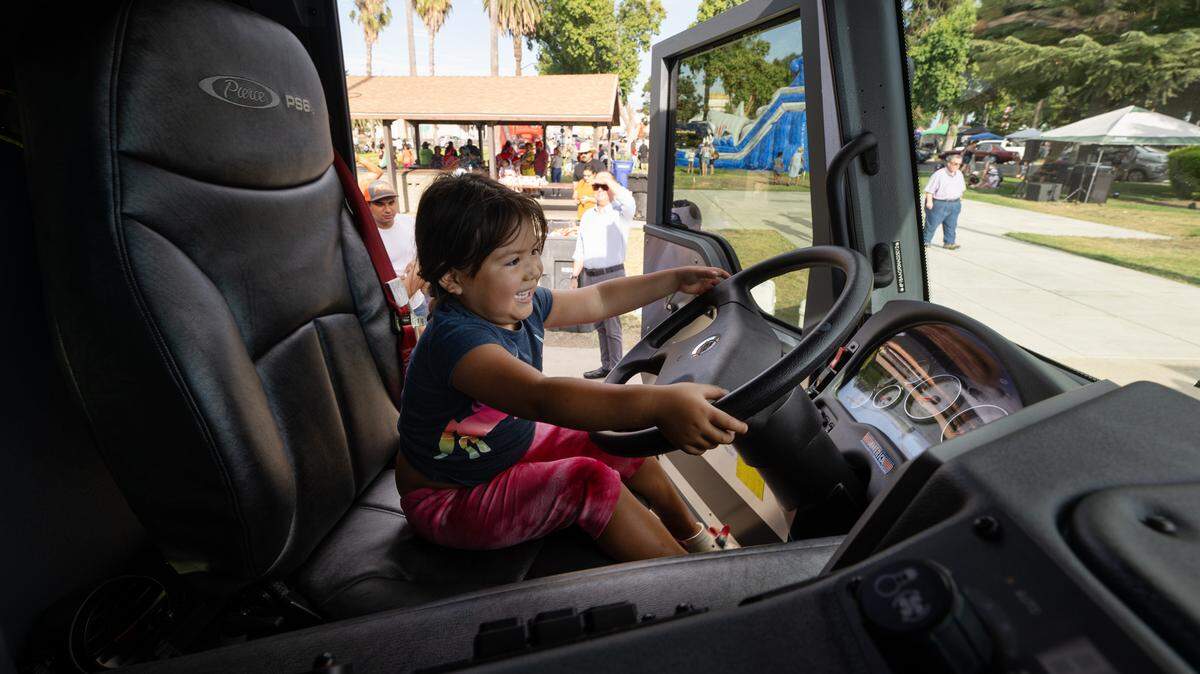 Sandra Vargas, 3, takes the wheel of the Patterson Fire Department’s new squad truck during National Night Out at North Park in Patterson, Calif., Tuesday, Aug. 1, 2023.