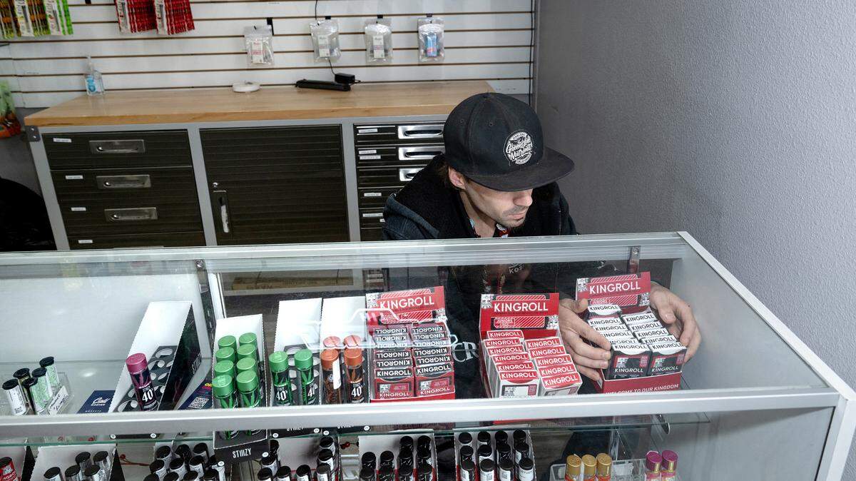 Cali Kosher clerk Lucas Hurst adjusts cannabis products at the Empire dispensary on Tuesday, Nov. 19, 2024.