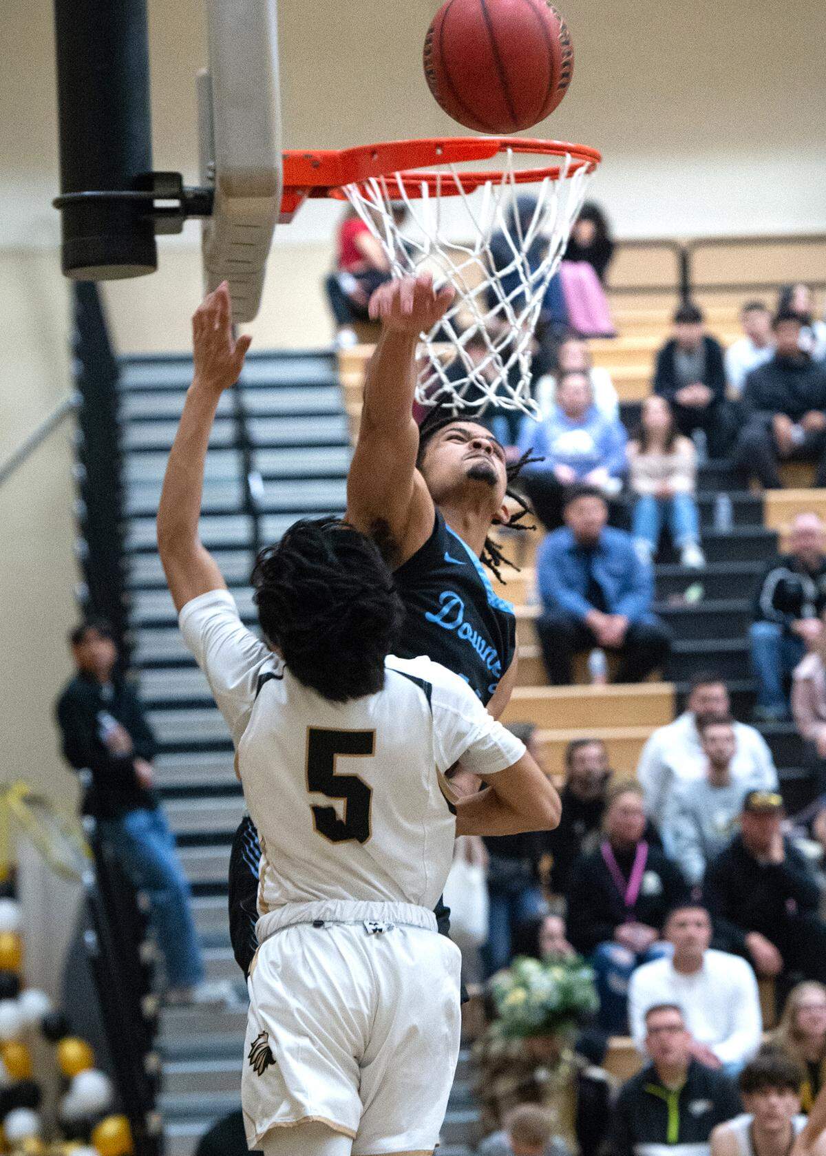 Downey’s Lloyd French blocks the layup attempt of Enochs’ Trent Acedillo during the Central California Athletic League game at Enochs High School in Modesto, Calif., Friday, Jan. 27, 2023.