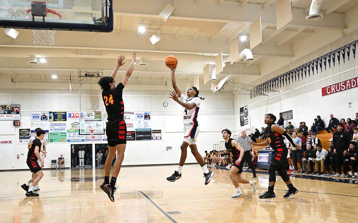 Modesto Christian’s Ross Widemon shoots over Berkeley’s Samir O’ Brien during a non-league game at Modesto Christian High School in Salida, Calif., Saturday, Dec. 16, 2023.