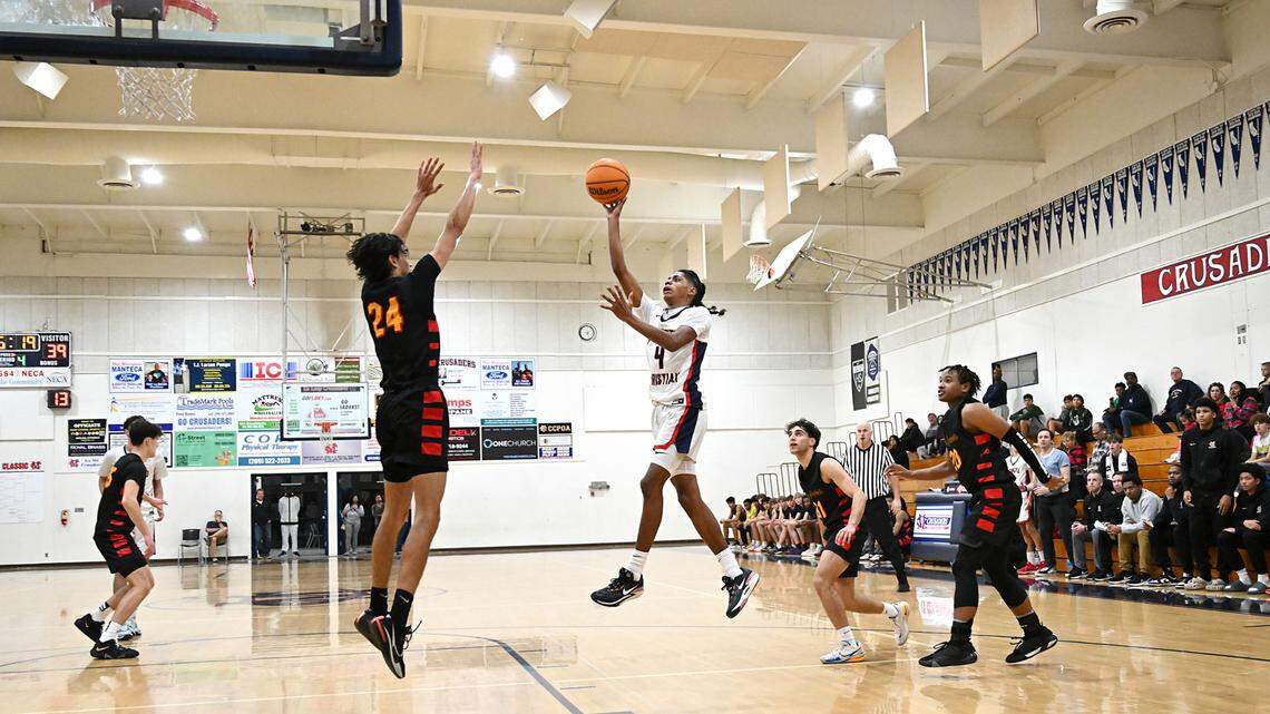 Modesto Christian’s Ross Widemon shoots over Berkeley’s Samir O’ Brien during a non-league game at Modesto Christian High School in Salida, Calif., Saturday, Dec. 16, 2023. 