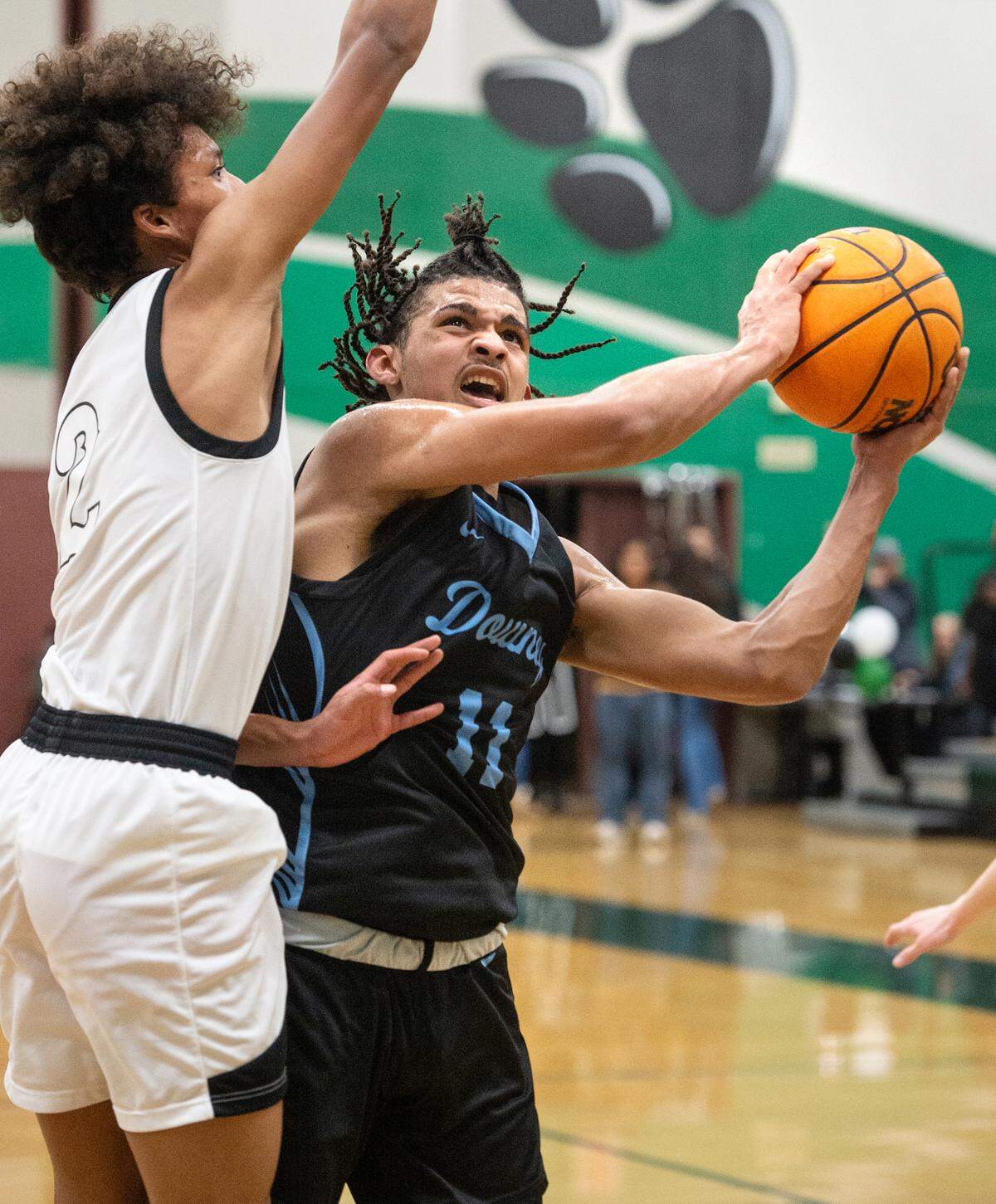 Downey’s Lloyd French scores past Pitman’s Cole Martin during the Central California Athletic League game in Turlock, Calif., Wednesday, Jan. 18, 2023. Downey won the game 52-44.