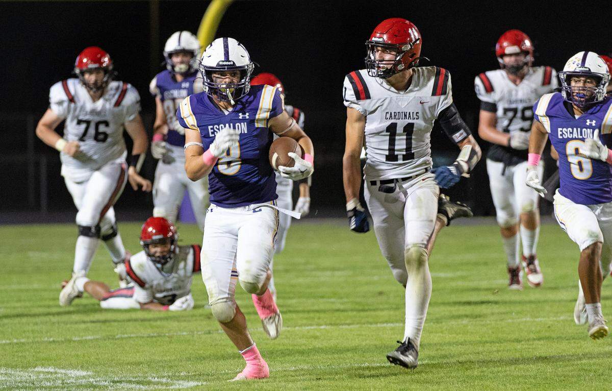 Escalon’s Carson Medina runs the ball during a non-league game against Woodland Christian at Escalon High School on Thursday, Oct. 10, 2024.