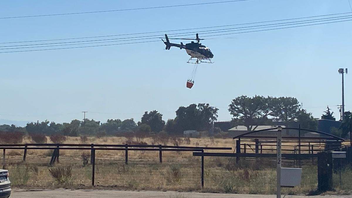 Fire crews from both Stanislaus and San Joaquin counties, assisted by Cal Fire and other agencies, battle a vegetation fire on both sides of McHenry Avenue near the Stanislaus River on Monday, July 3, 2023.