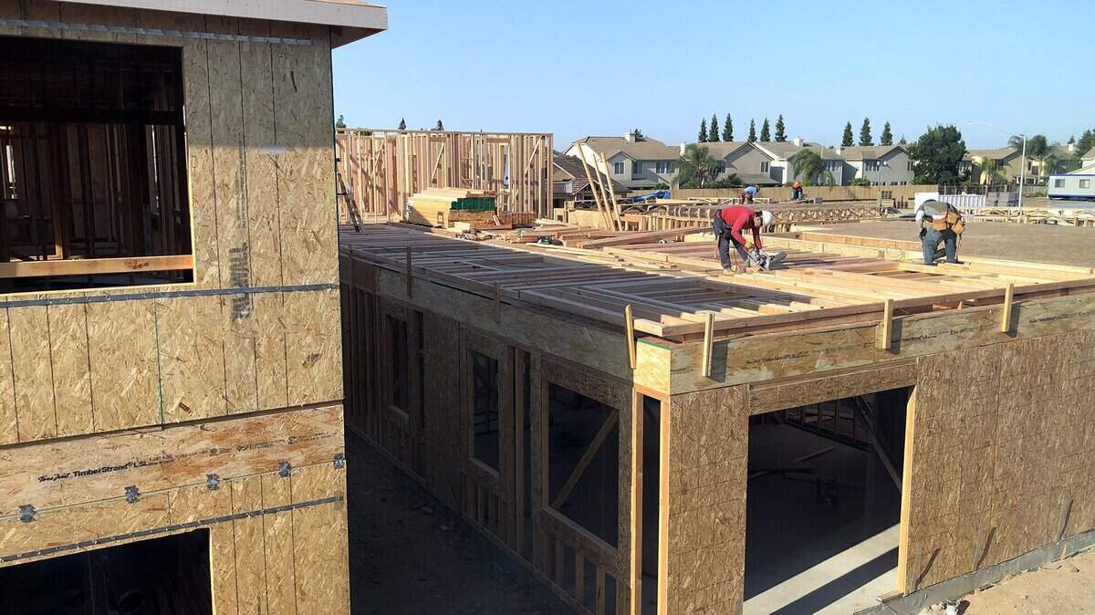 Construction workers build houses in The Groves subdivision on Lookout Drive in the Village 1 neighborhood of Modesto, Calif. on Thursday June 4, 2018.