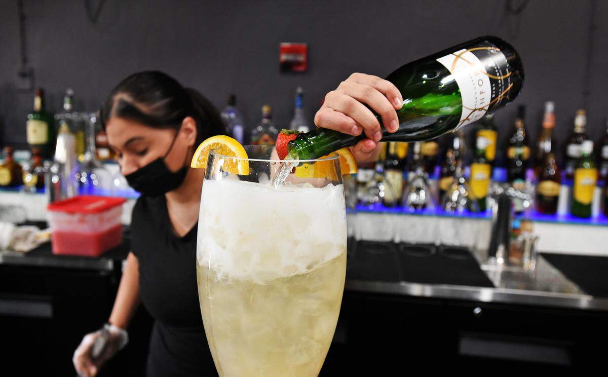 Bartender Nikki Baca makes a Super Mimosa at My Mimosas restaurant in Modesto, Calif., on Friday, Aug. 14, 2020.