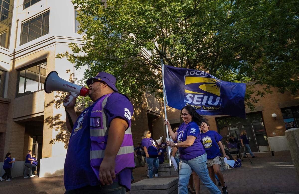 Service Employees International Union Local 521 members rally outside the Stanislaus County offices at 10th Street Place in Modesto, Tuesday, Sept. 16, 2025. 