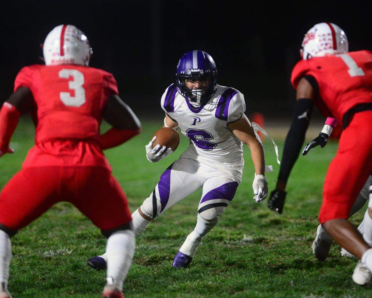 Pacheco running back Abel Bravo tries to cut back against two Ceres defenders during a game between Ceres High School and Pacheco High School at Ceres High School in Ceres California on October 7, 2022.