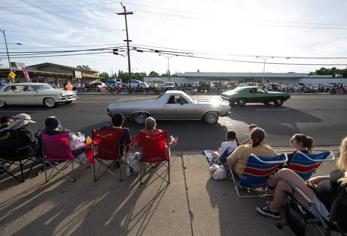 Classic car owners cruise down McHenry Avenue during the Graffiti Parade in Modesto, Calif., Friday, June 9, 2023.