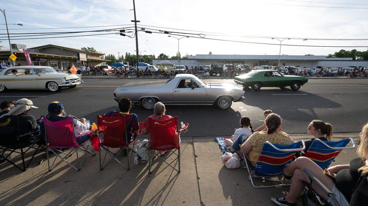 Classic car owners cruise down McHenry Avenue during the Graffiti Parade in Modesto, Calif., Friday, June 9, 2023.