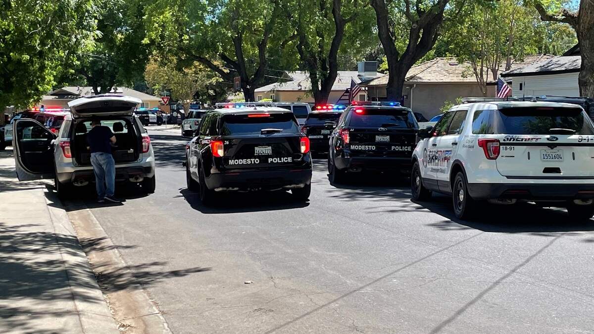 Police converge on a Modesto neighborhood where an individual was fatally shot Sunday, July 10, 2022.