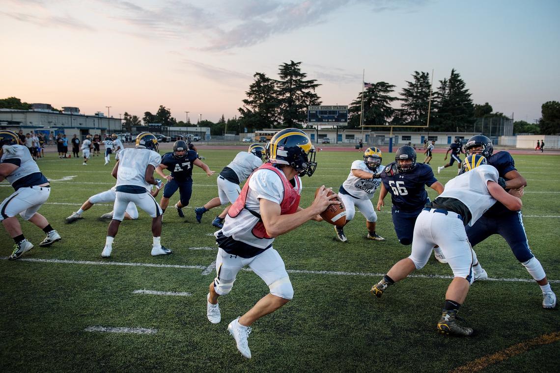 Gregori quarterback Baker Melendez rolls out to pass during a preseason scrimmage with Downey at Downey High School in Modesto, Calif., Friday, August 10, 2018. 