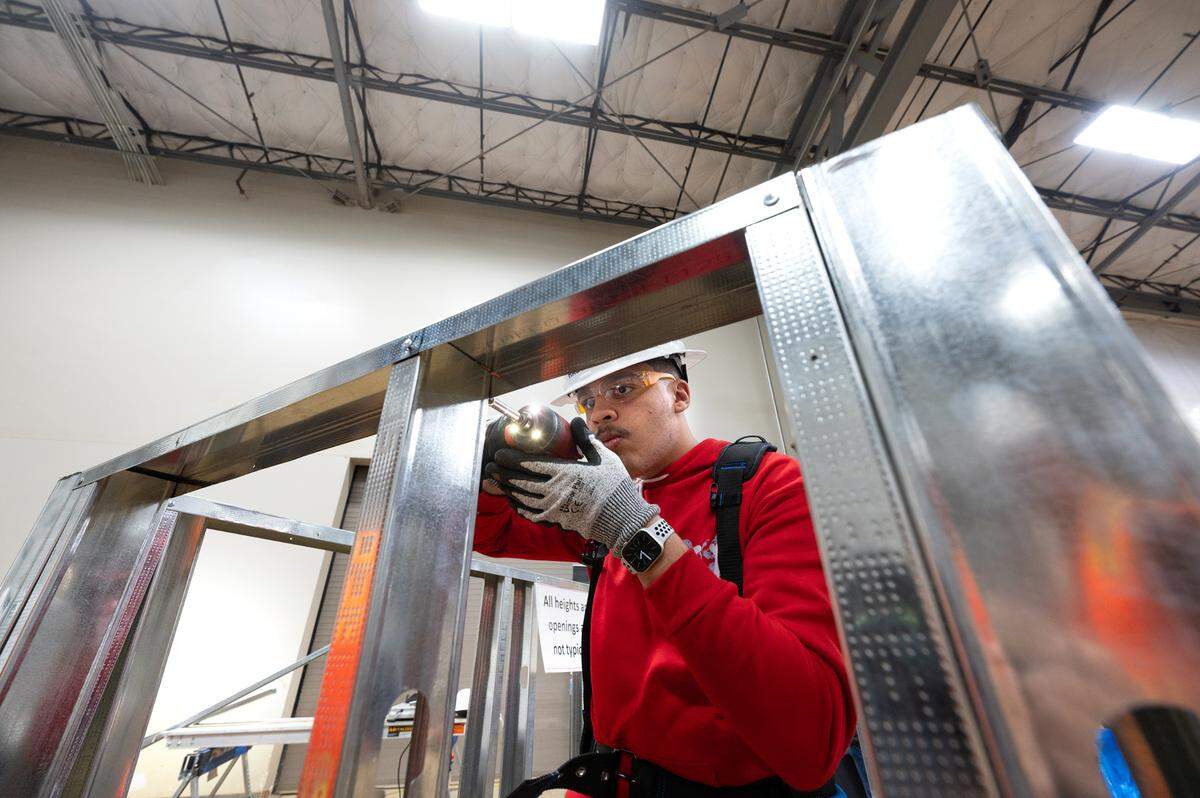 Delta Charter High School student Ahmad Sarama tests framing techniques during Construction Trades Day at the Modesto Junior College West Campus in Modesto, Calif., Wednesday Nov. 15, 2023. The event was organized by the Valley Builders Exchange, a Modesto-based group that helps contractors with hiring and training.