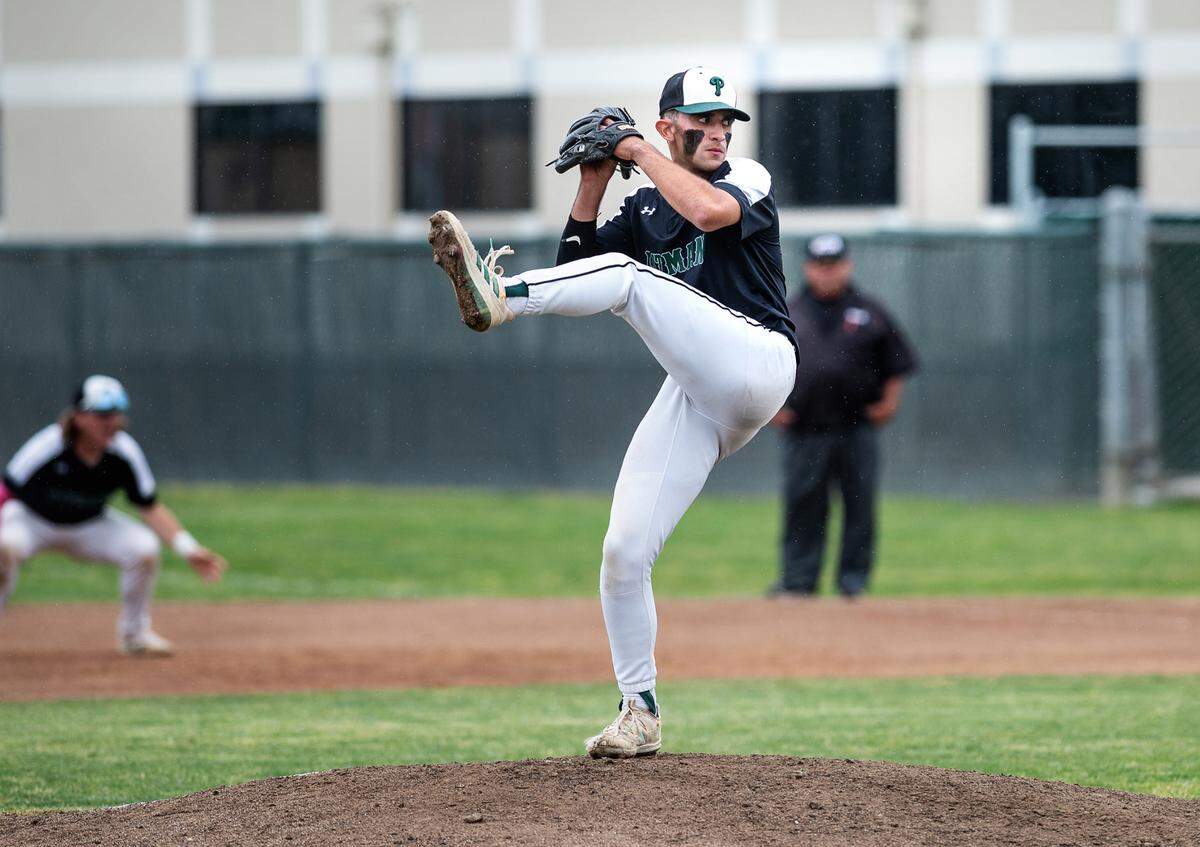 Mateo Garcia delivers a pitch during a California Athletic League game with Turlock at Pitman High School in Turlock, Calif., on Thursday, April 14, 2022.