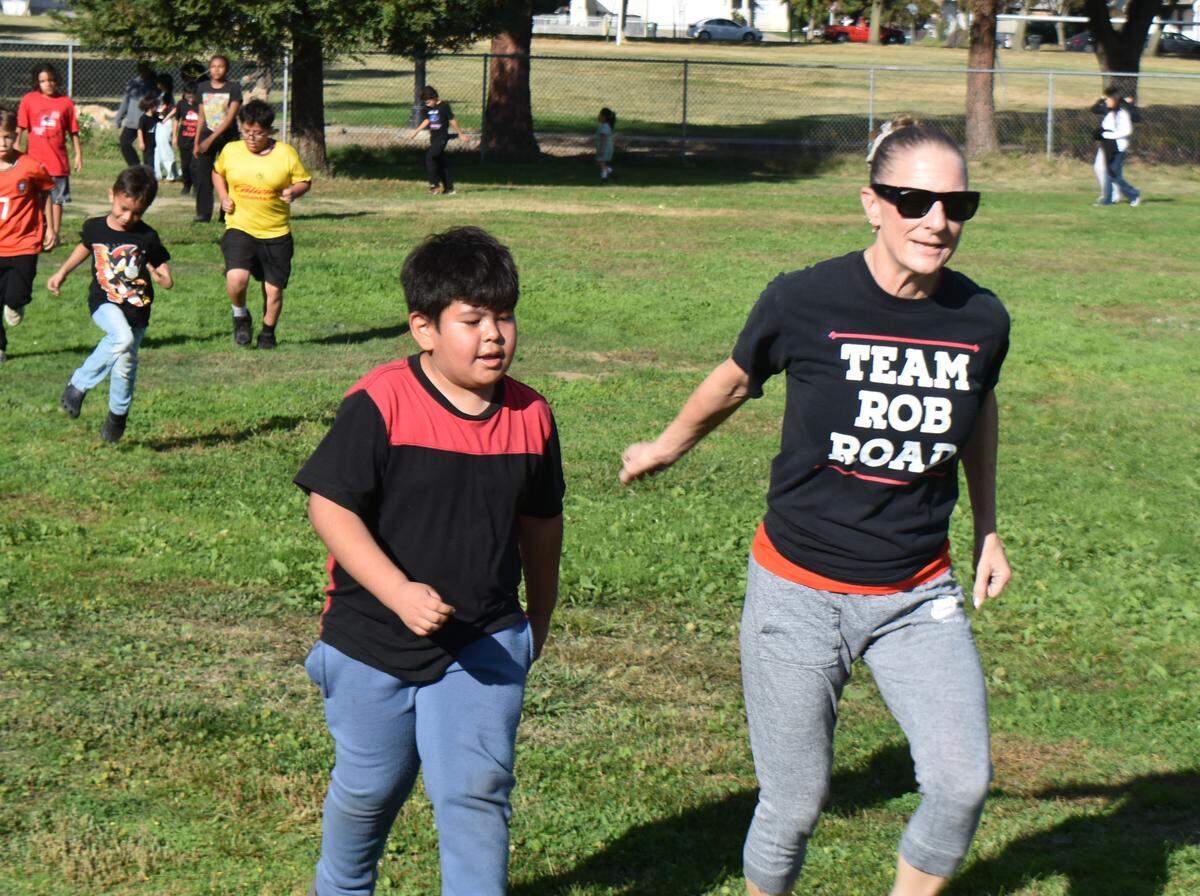 Fifth-grade teacher Kendra Shervington joins students at Modesto’s Robertson Road Elementary School for their regular Friday afternoon 1-mile run around a school field. Photographed Nov. 7, 2025.