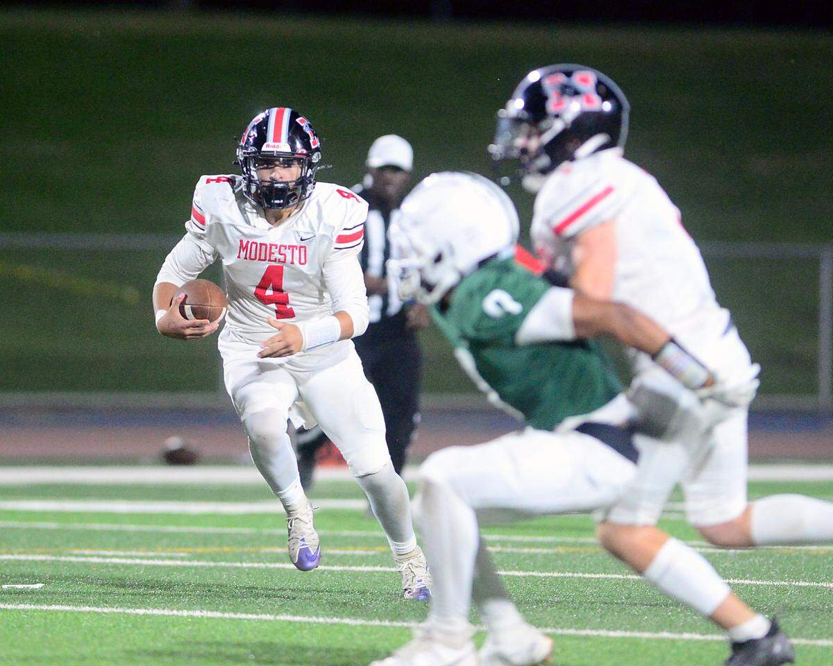 Modesto High quarterback Israel Ceniceros (4) takes off to scramble out of the pocket during a game between Modesto High School and Central Valley High School at Gregori High School in Modesto, Calif., on Sept. 13, 2024.