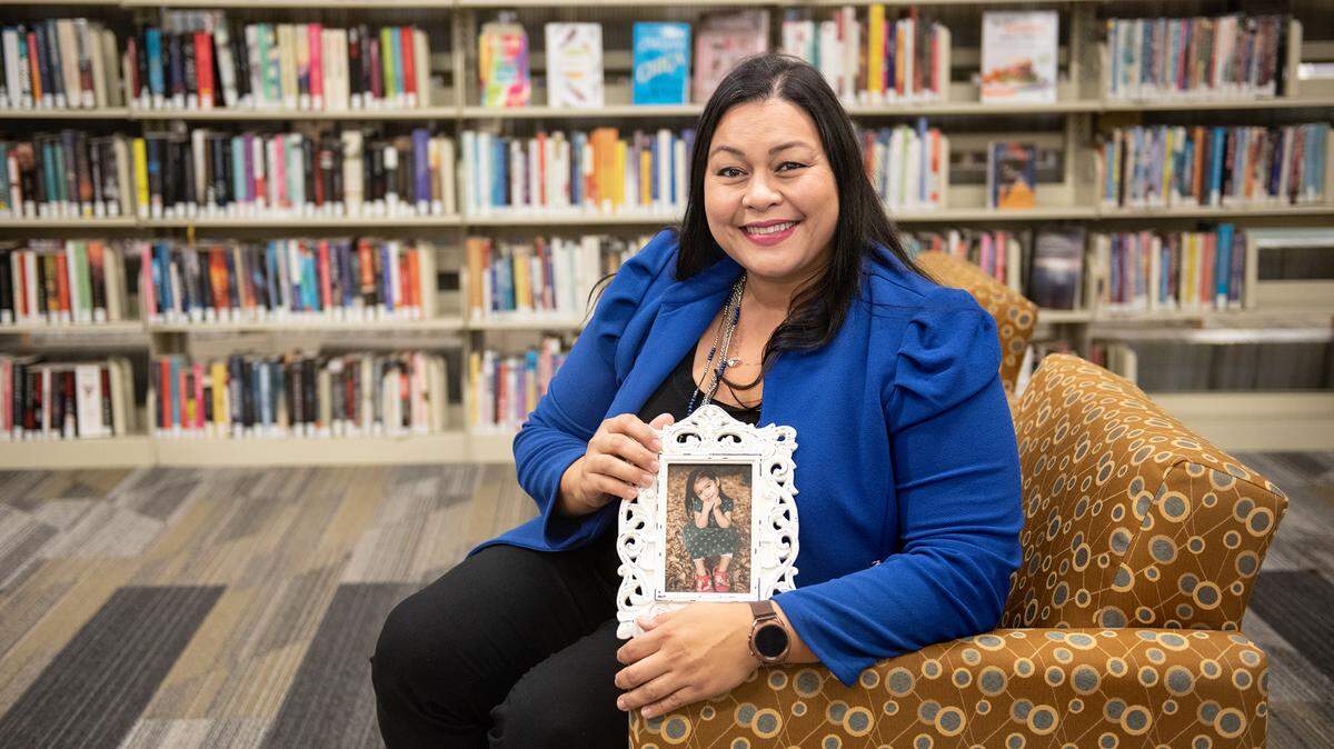 Meshell Alcantar holds a picture of her daughter Vivian Mae, 4, in Turlock, Calif., Wednesday, Dec. 1, 2022. She is suing California State University, Stanislaus, for being fired while she was pregnant with Vivian Mae.