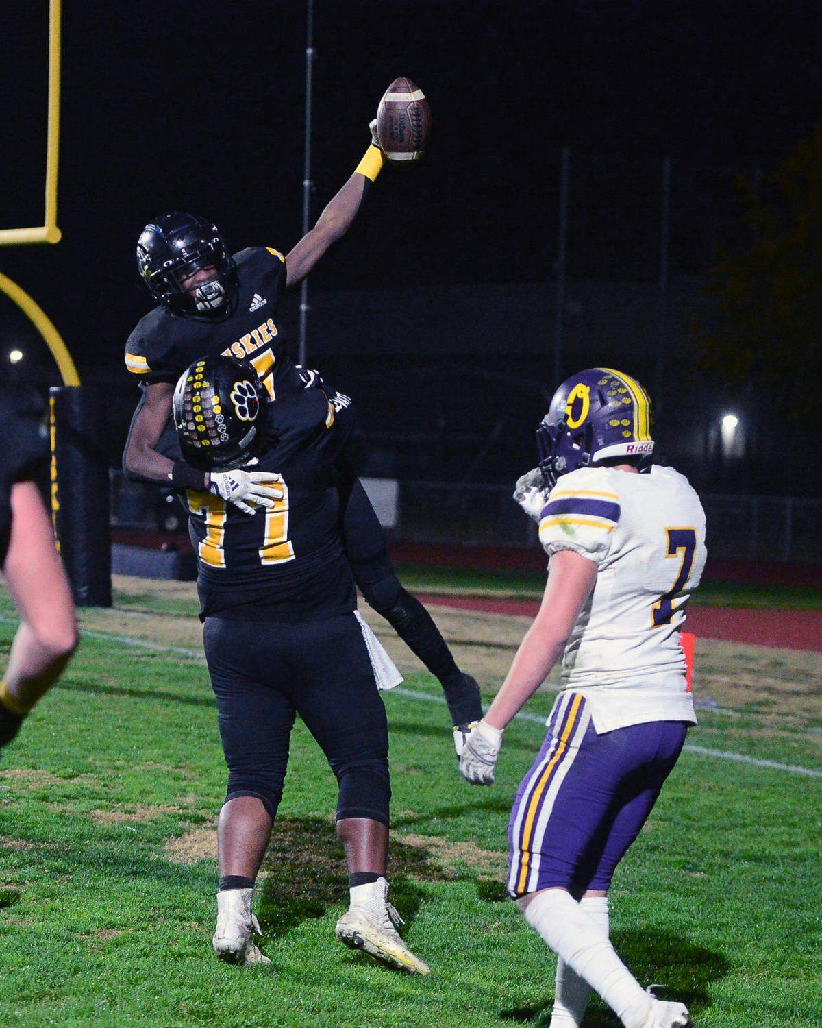 Hughson receiver Malakai Sumter (7) celebrates with teammates after catching the winining touchdown during a Sac-Joaquin Section Division VI playoff game against Orestimba in Hughson, California, on Nov. 18, 2022. Hughson won 21-17.