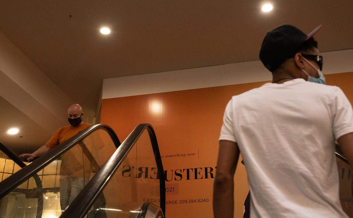 Shoppers use the escalator at the second floor entrance to the future Dave & Buster’s entertainment center at Vintage Faire Mall in Modesto, Calif., on Friday, April 2, 2021.