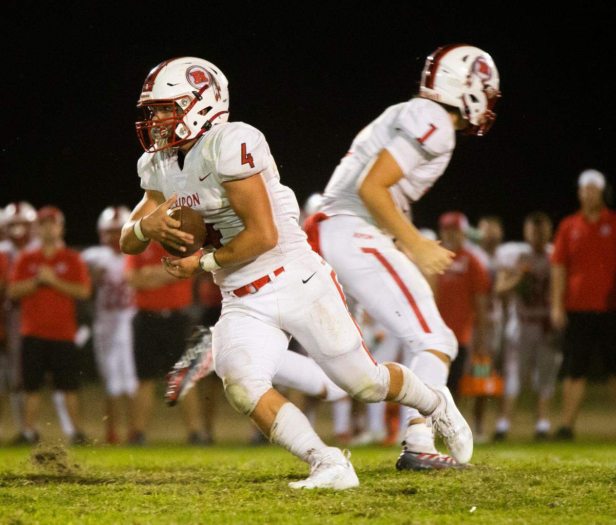 Anden Ries, 4, of Ripon High gets the handoff and looks upfield for some yards. Ripon vs Hilmar at Hilmar Sept. 23, 2022.