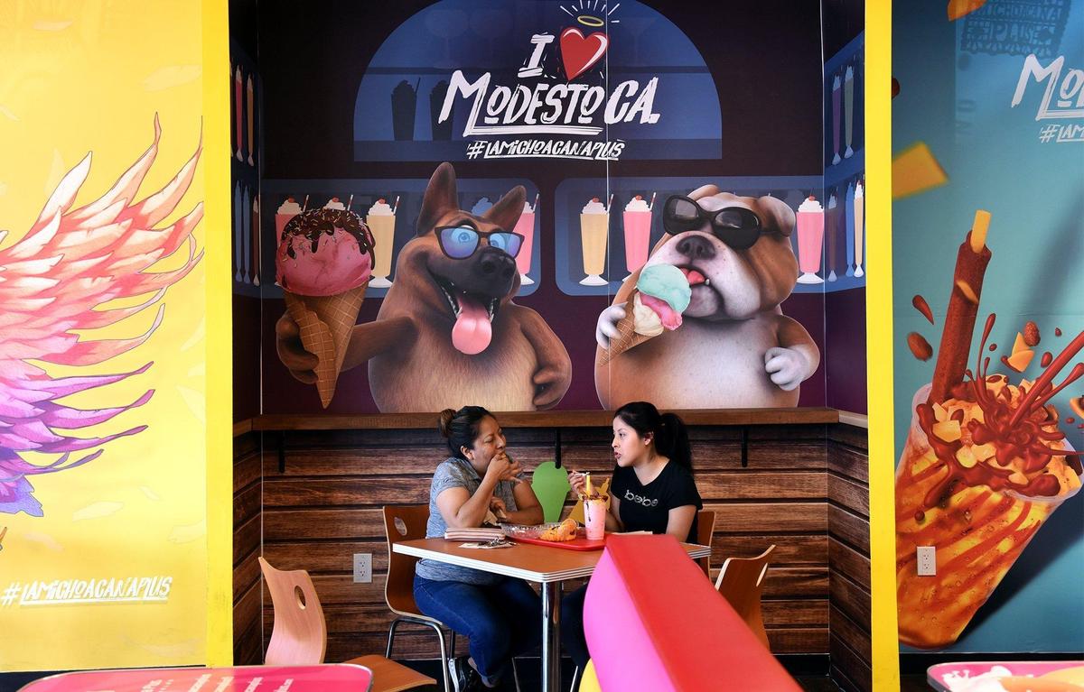 Mother and daughter Nancy (left) and Karen Garcia enjoy their order on Wednesday afternoon June 19, 2019 at La Michoacana Plus in Modesto, Calif.