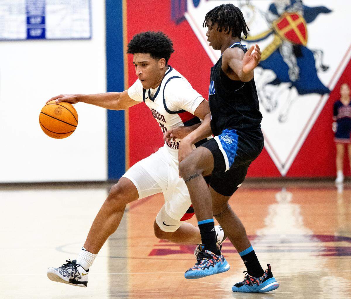 Modesto Christian guard Gavin Sykes moves the ball as Oakland’s Da’sean Armstrong defends during a game at Modesto Christian High School in Salida, Tuesday, Dec. 3, 2024.