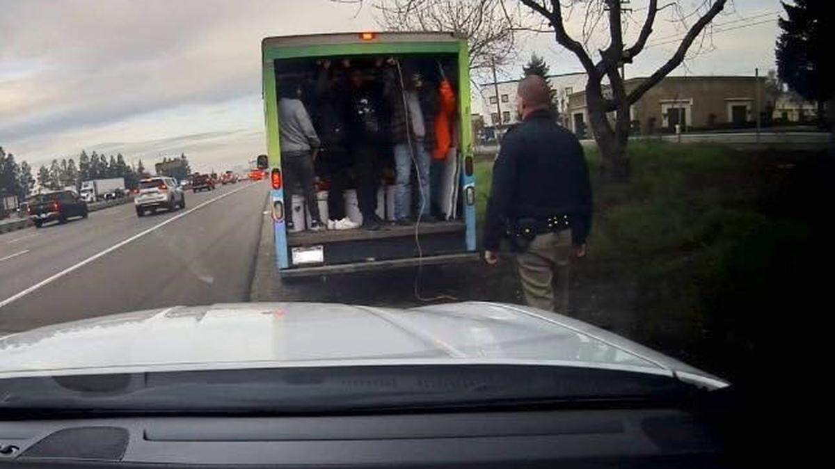 Motorists called 911 Tuesday morning, Feb. 13, 2024, to report this GMC box truck on Higway 99 in Modesto with its rear door partially cracked, revealing several people standing in the cargo area.