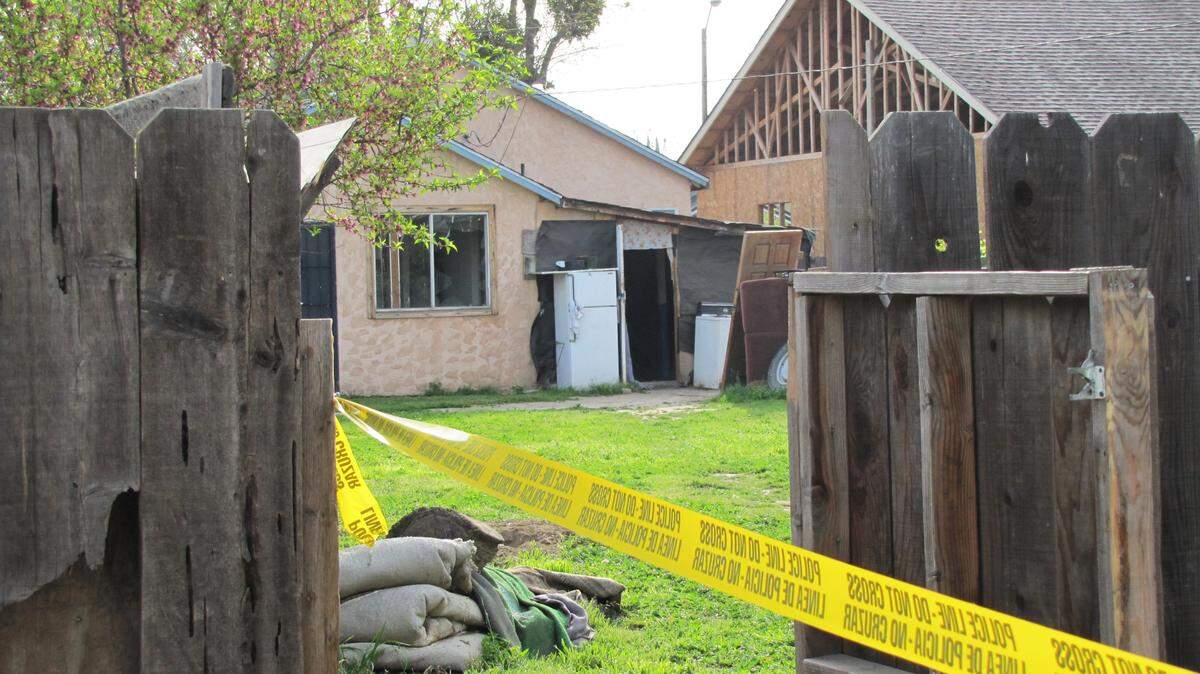 Pictured is the back yard of a home in the 600 block of Thrasher Avenue in Modesto, California. On Wednesday March 24, 2010, Julio Jimenez was found in the back yard with multiple gunshot wounds. He later died as the result of a botched home-invasion robbery.